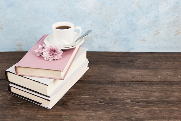 High angle of a coffee on books