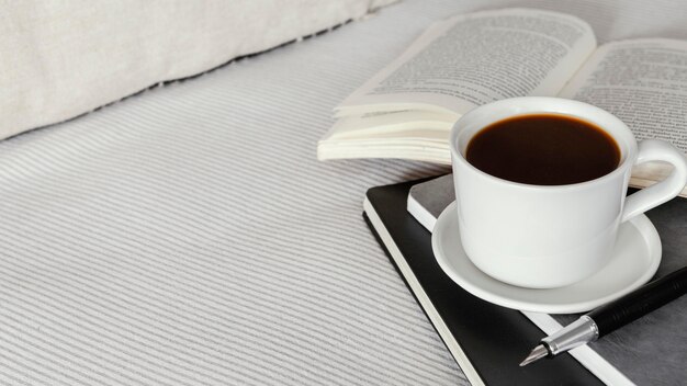 High angle coffee cup and book