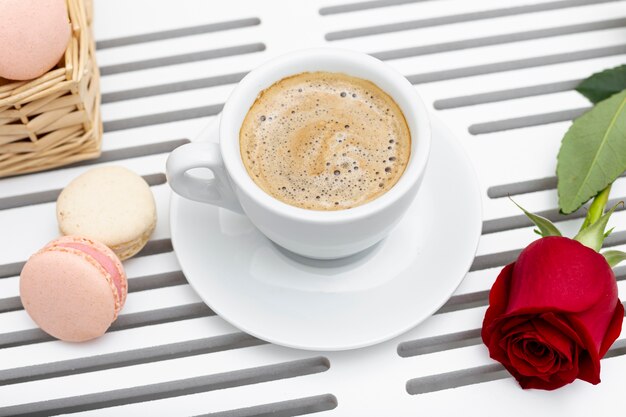 High angle of coffee cup and rose for valentines day