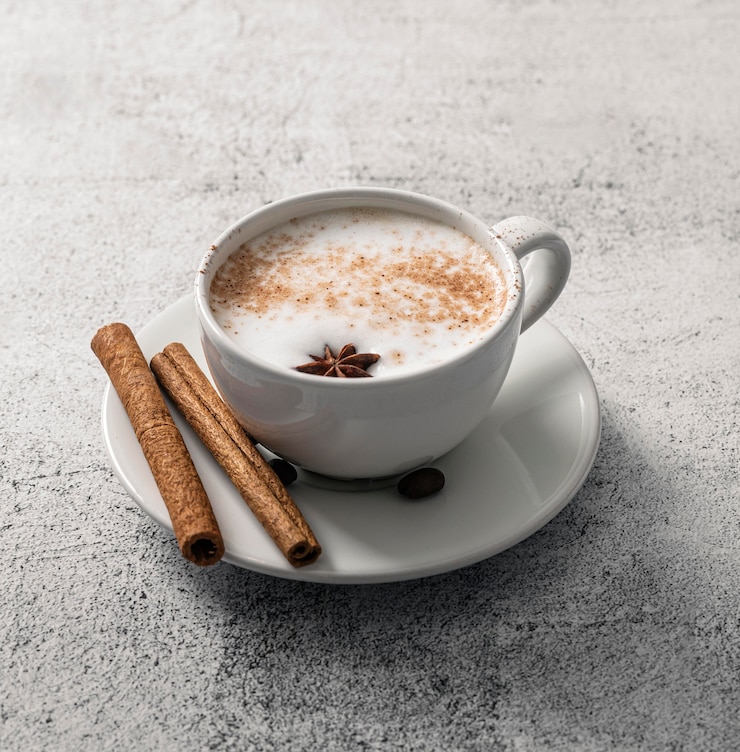 Free Photo high angle of coffee cup with cinnamon sticks and star anise