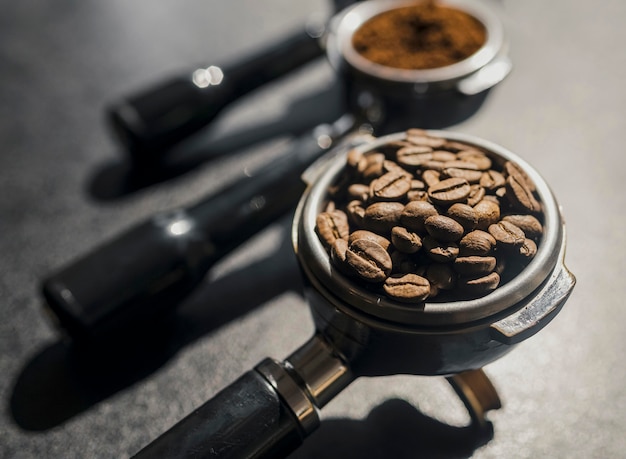 Free photo high angle of coffee machine cups with coffee beans