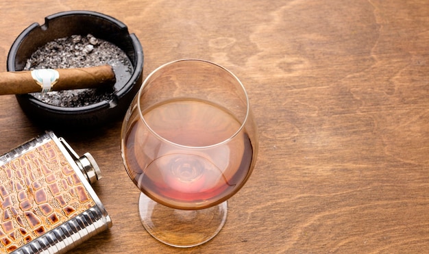 High angle cognac and cigar with copy space