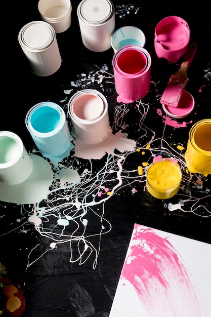 High angle of colored paint cans