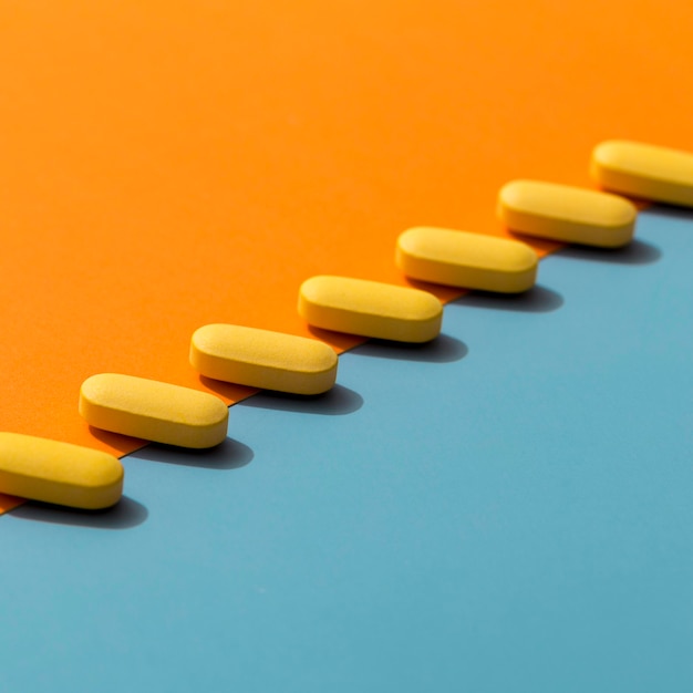 Free photo high angle of colored pills in a row