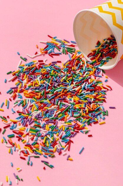 High angle of colorful cup spill of sprinkles