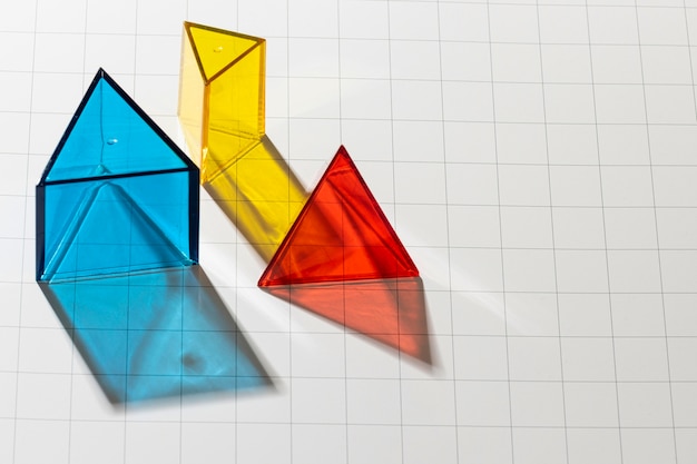 High angle of colorful translucent geometric shapes with copy space