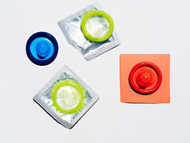 High angle colourful condoms on white background