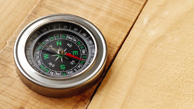 High angle compass on wooden board with copy-space