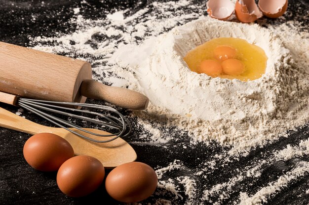 Free photo high angle composition with eggs and flour