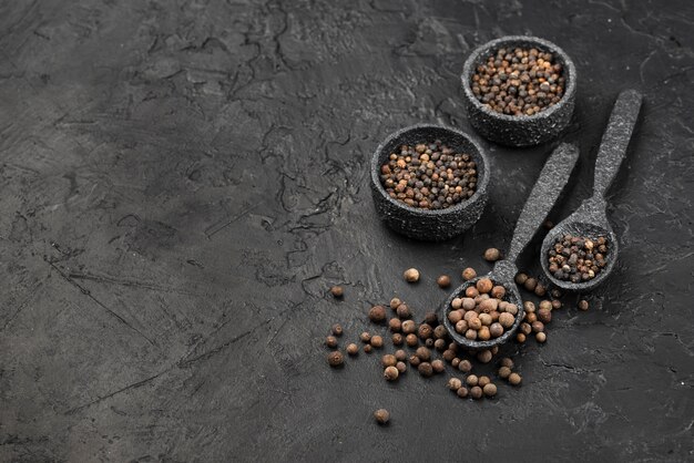 High angle of condiments and seeds in bowls with slate