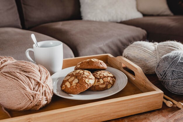 High angle cookies anf yarn with cup on tray