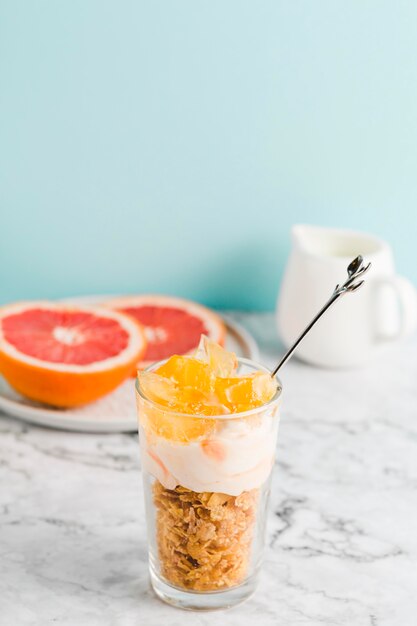 High angle cornflakes with yogurt and fruits in glass