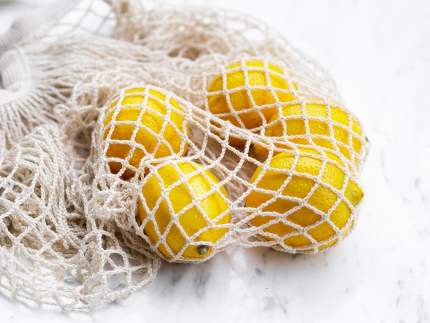 Free photo high angle cotton net bag with citrus