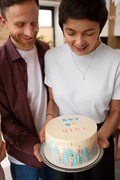 High angle couple holding cute cake