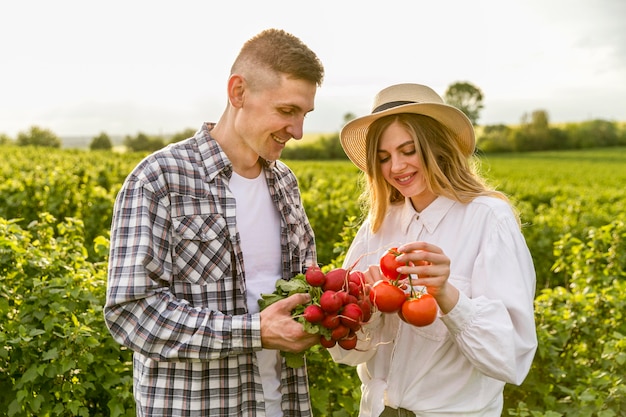 High angle couple holding vegetables