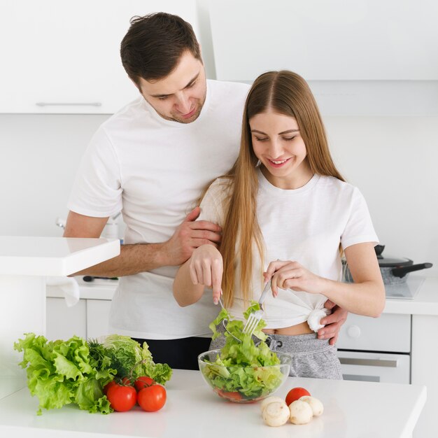 High angle couple making salad