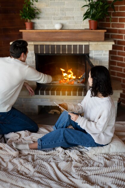 High angle couple sitting by the fire