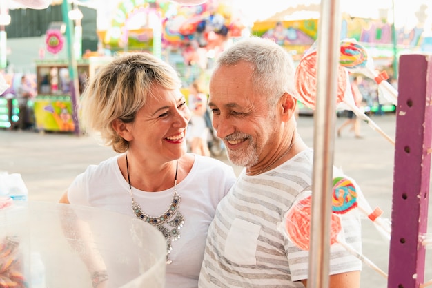 High angle couple smiling in amusement park