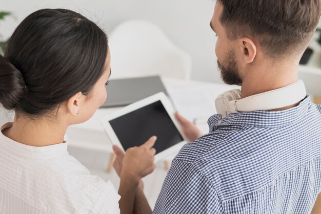 High angle coworkers looking at tablet