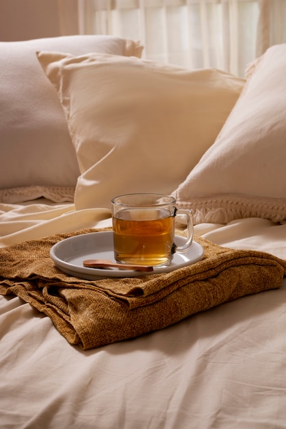 Free photo high angle cozy bed arrangement with tea