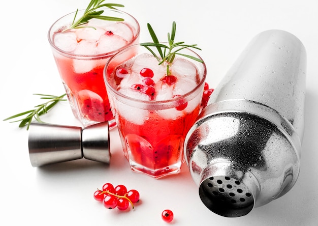 High angle cranberry vodka glass with ice and shaker