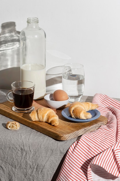 High angle of croissants on plate and egg with milk