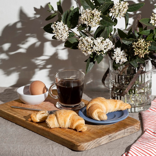 High angle of croissants on plate with coffee