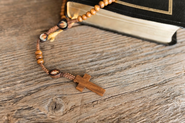 High angle of cross rosary with holy book