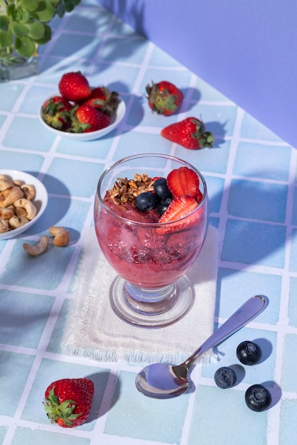 high angle cup of açai dessert with berries