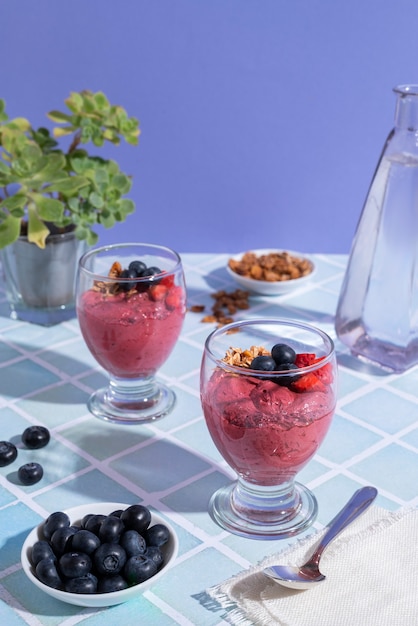 high angle cup of açai dessert with blueberries