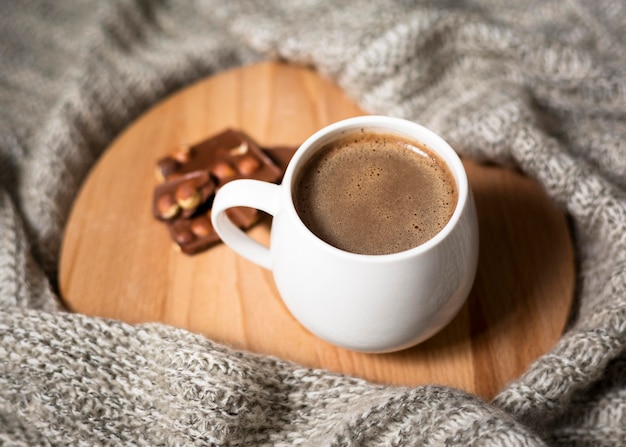 High angle cup of coffee on wooden board