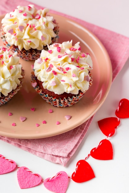 Free photo high angle of cupcakes on plate with hearts