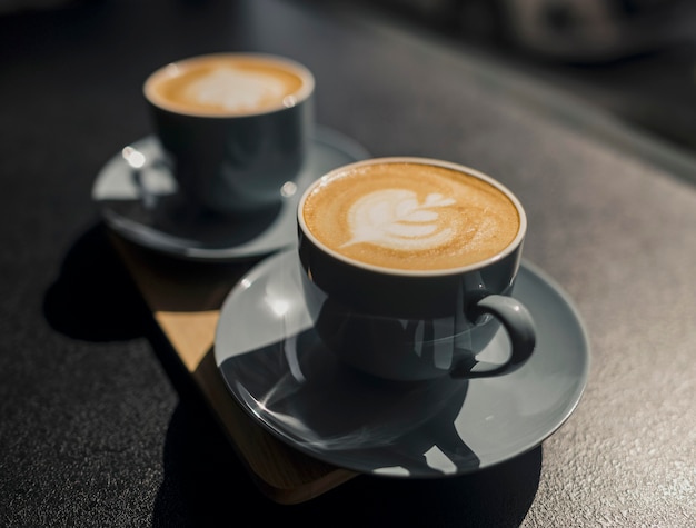 High angle of cups of coffee made by barista