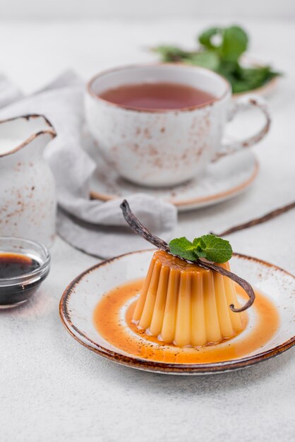 High angle of custard on plate with mint and vanilla pod