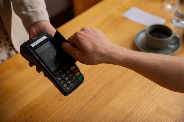 High angle customer paying with nfc device