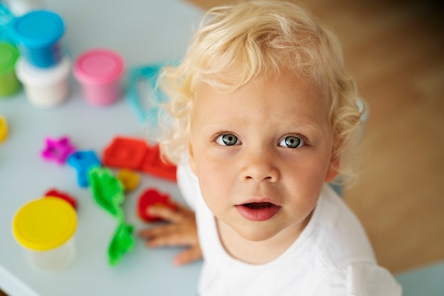 high angle cute blonde kid indoors