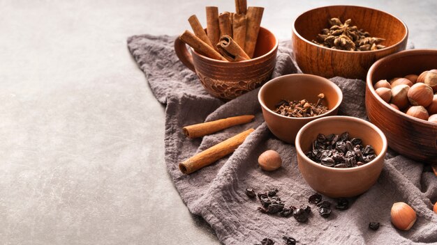 High angle decoration with cinnamon sticks and hazelnuts in bowls