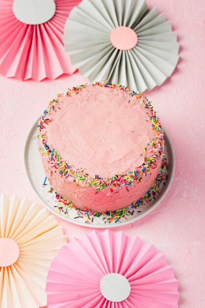 High angle decoration with ornaments and pink cake