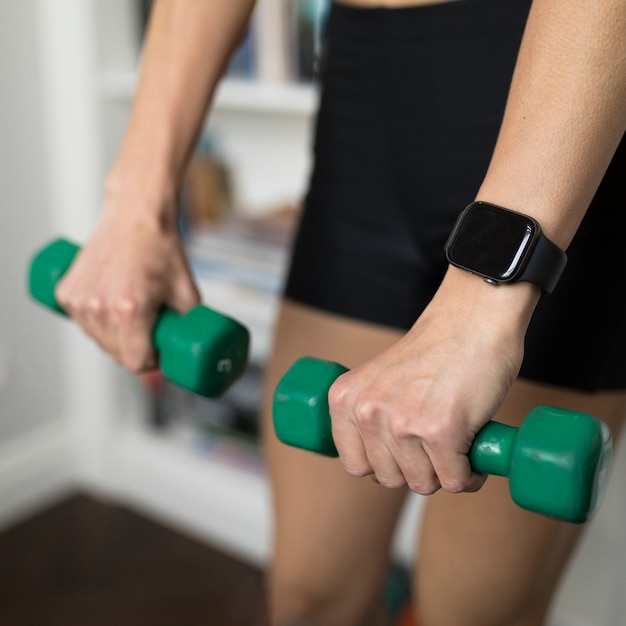 Free photo high angle of defocused woman using weights