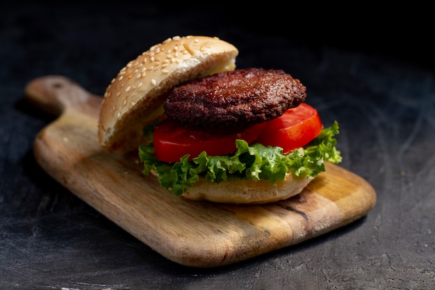 High angle delicious burger on wooden board