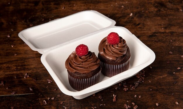 High angle of delicious chocolate cupcakes with raspberry