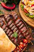 Free photo high angle of delicious kebab with vegetables and herbs