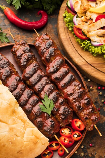 High angle of delicious kebab with vegetables and herbs