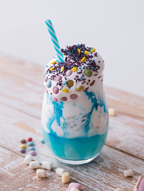 High angle of delicious milkshake on wooden table