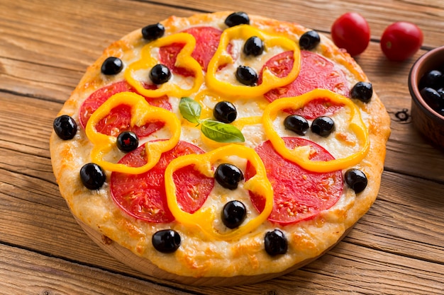 Free photo high angle of delicious pizza on wooden table