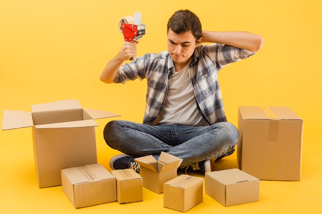 Free photo high angle delivery man prepared to wrap up delivery packages