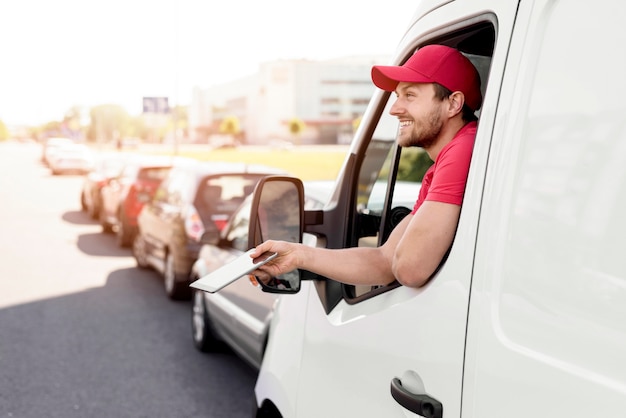 High angle delivery man with mobile