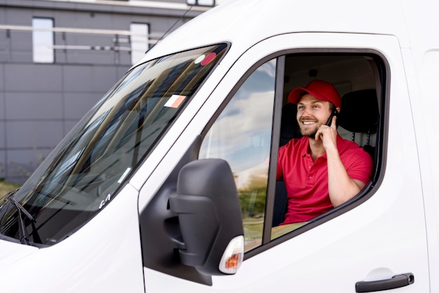 High angle delivery service man talking over phone