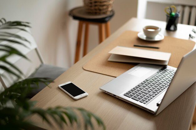 Free Photo high angle desk arrangement with laptop