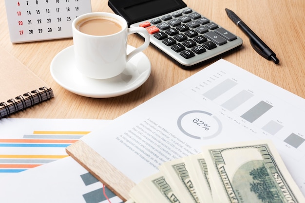 High angle desk with cash and coffee